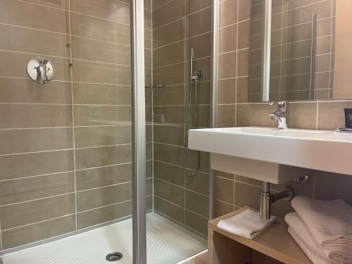 a bathroom with a shower and a sink at Garda Sporting Club Hotel in Riva del Garda