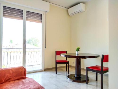 a living room with a table and red chairs at Casa Bignardi - Affitti Brevi Italia in Modena