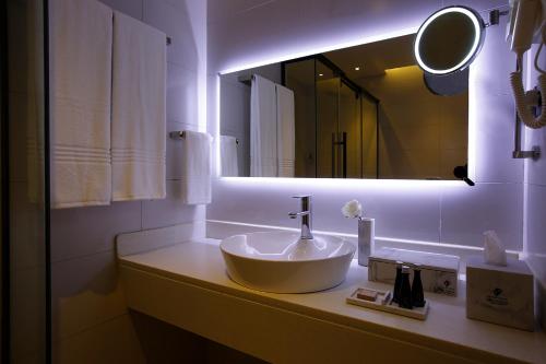 a bathroom with a sink and a mirror at Grand Plaza Hotel - Jazan in Jazan