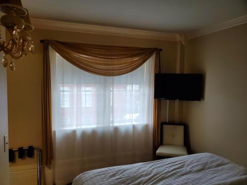 a bedroom with a window with a bed and a chair at Lowell Inn in Stillwater