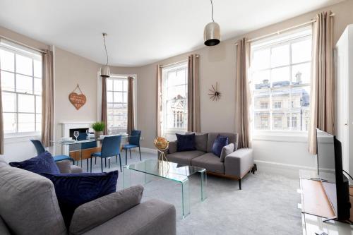 
a living room filled with furniture and a window at 2 Bedroom High Street Duplex Apartment in Cheltenham
