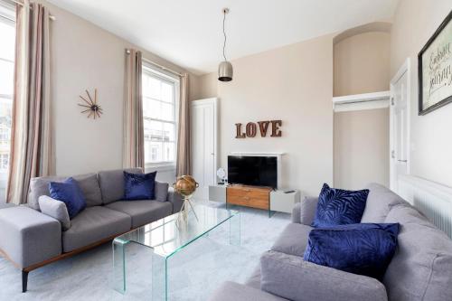 
a living room filled with furniture and a fire place at 2 Bedroom High Street Duplex Apartment in Cheltenham
