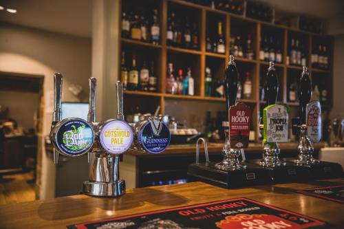 a bar with lots of signs on the counter at The Red Lion at Hellidon in Daventry