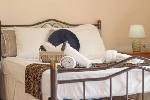 a bed with a clock and other items on it at Endless Blue Seaside in Paleo Tsifliki