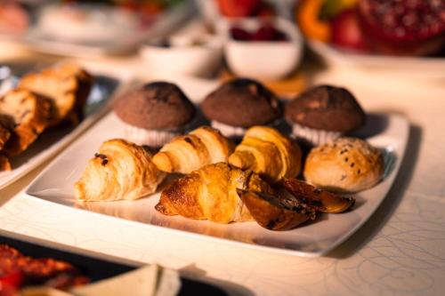 a plate of pastries and muffins on a table at Tamaris Rooms in Zadar