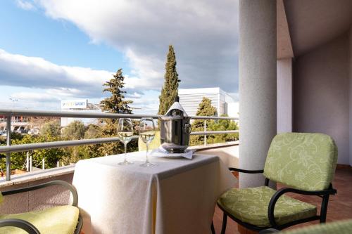 a table and two chairs on a balcony with a view at Tamaris Rooms in Zadar