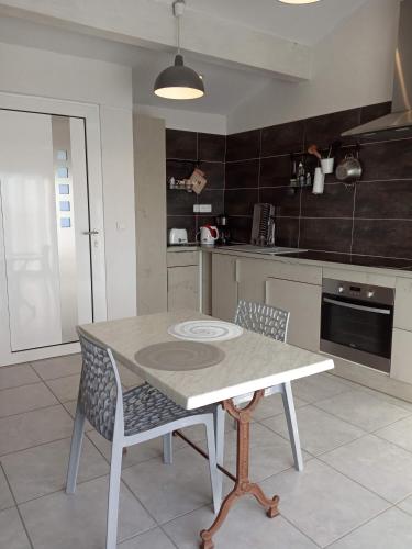 une cuisine avec une table et des chaises dans une pièce dans l'établissement Chez Pierre, à Bélesta