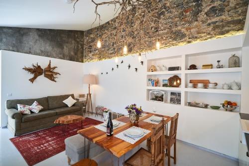a living room with a table and a couch at Sparrow Sintra Nest in Sintra