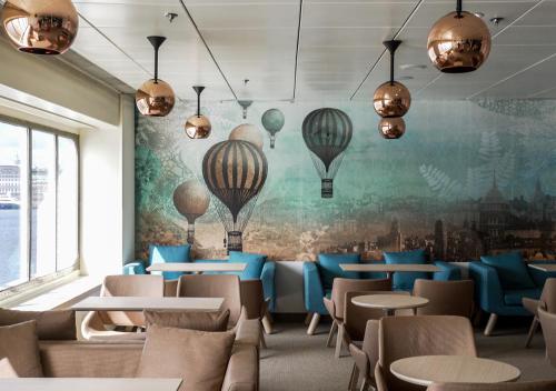 a restaurant with a mural of hot air balloons at Viking Line ferry Gabriella - One-way journey from Helsinki to Stockholm in Helsinki