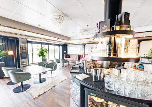 a restaurant with a bar with chairs and tables at Viking Line ferry Gabriella - One-way journey from Helsinki to Stockholm in Helsinki