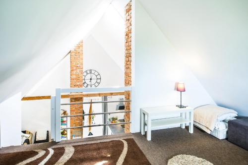 a living room with a bed and a table at GRAPA LOFT Dom w Górach Apartament Wypoczynek w górach in Lipnica Wielka