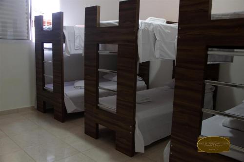 a room with three bunk beds in a room at Chalé Recanto Monte Sinai in Piracaia