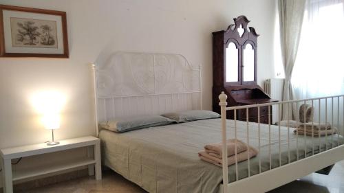 a bedroom with a white bed and a window at Piccinni house in Bari