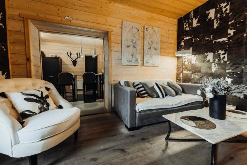 a living room with a couch and a table at Cozy apartment near the city center in Megève