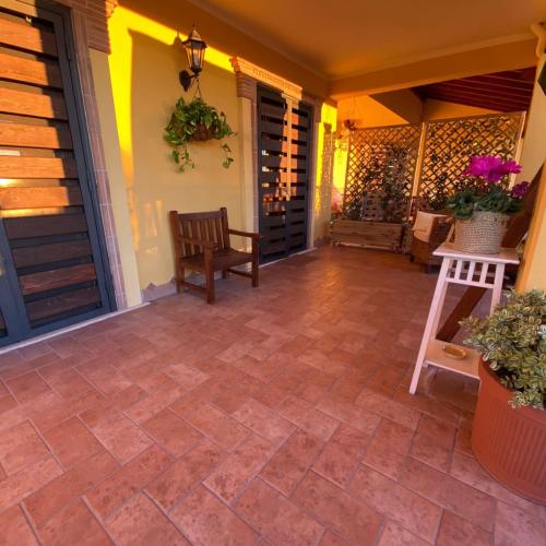 a screened porch with a bench and a house at Alloggio turistico La Maison de Matì in Monterotondo