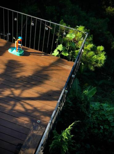 a toy on a wooden deck with a fence at La Villa Da Lat in Khu Chi Lăng