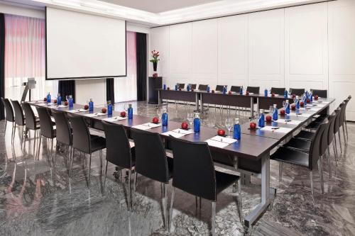 a large conference room with a long table and chairs at Hotel Colón Gran Meliá - The Leading Hotels of the World in Seville