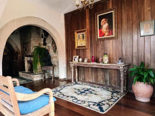 a living room with a fireplace and a painting on the wall at Casa da Kau in Ouro Preto