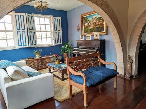 a living room with a couch and a piano at Casa da Kau in Ouro Preto