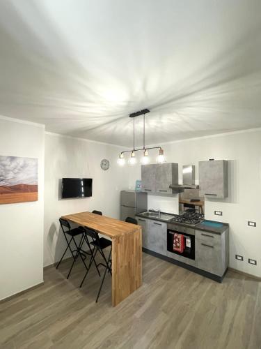 - une cuisine avec une table en bois et une cuisinière dans l'établissement incantevole casa vacanze con parcheggio, à Pise