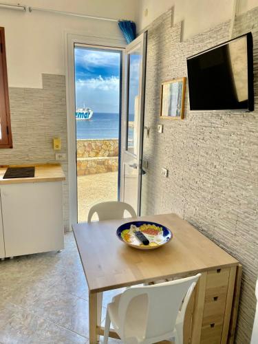 a kitchen with a table with a bowl of food on it at Il Muretto in Marettimo