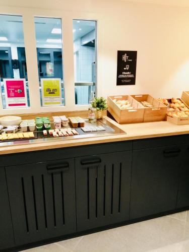 a counter in a store with food on it at ibis Beaune Centre in Beaune
