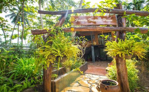 a sign in front of a building with plants at Andalay Beach Resort Koh Libong in Ko Libong