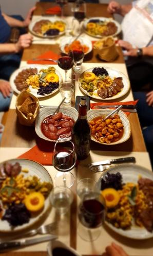 a long table with plates of food and glasses of wine at Antica Osteria Ghiridone in Palagnedra