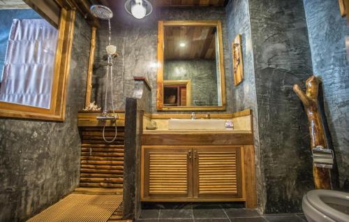 a bathroom with a sink and a mirror at Andalay Beach Resort Koh Libong in Ko Libong