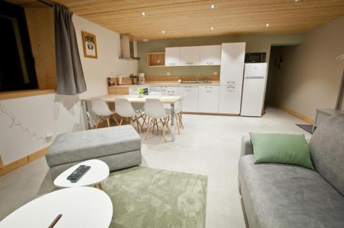 a living room with a couch and a table at Appartement Chalet Louison in Les Gets