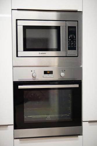 a microwave oven sitting inside of a kitchen at Spacious Fully Equipped 3BD 2Bath Apt in the heart of city with Balconies AC and fast WIFI #1 in Heraklio Town