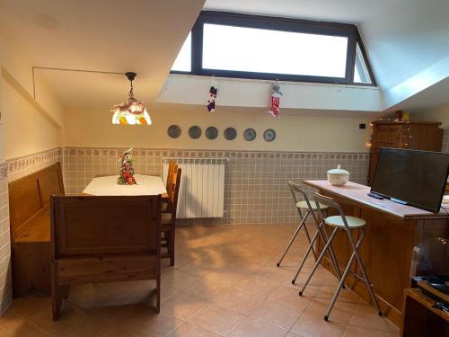 ein Esszimmer mit einem Tisch und einem Fenster in der Unterkunft La Petite Maison in Ateleta
