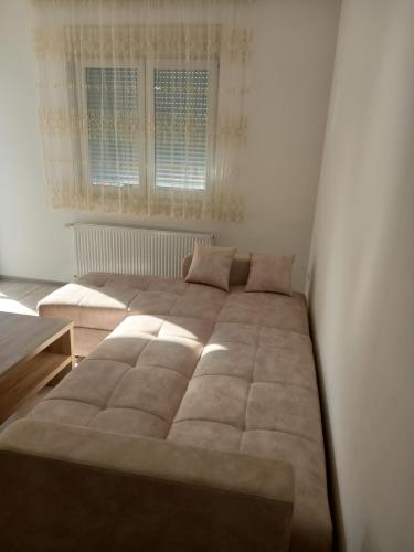 a large bed in a room with a window at Apartman Vasilije Banja Koviljaca in Banja Koviljača