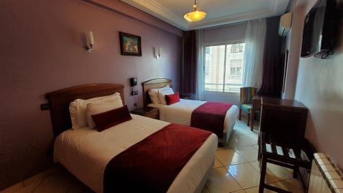 Postelja oz. postelje v sobi nastanitve Hôtel Amouday