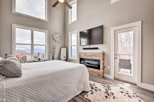 a bedroom with a bed and a tv on the wall at Scenic Hillside Cabin in Sylva with Hot Tub and Views! in Sylva