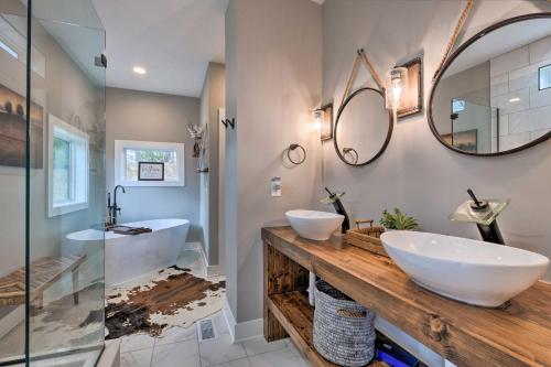 a bathroom with two sinks and a mirror at Scenic Hillside Cabin in Sylva with Hot Tub and Views! in Sylva