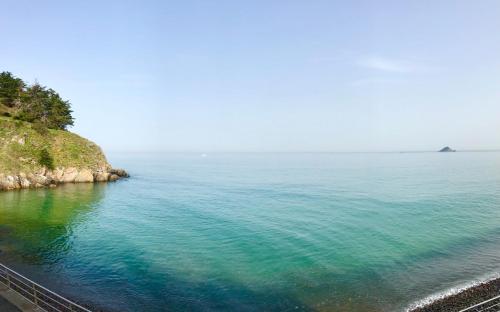an aerial view of the ocean next to a cliff at Grand studio Clémenceau Vue mer 3 étoiles in Pléneuf-Val-André