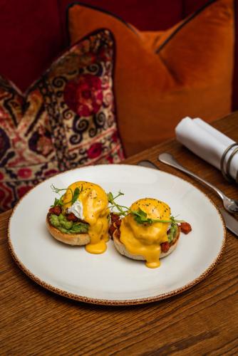 two egg sandwiches on a plate on a table at King Street Townhouse in Manchester