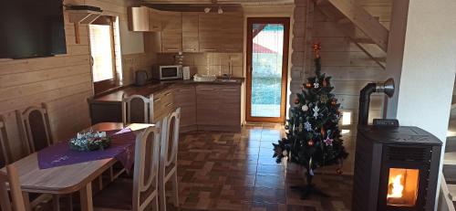 a kitchen with a christmas tree in the middle of it at Drevenička Rybička in Liptovský Trnovec