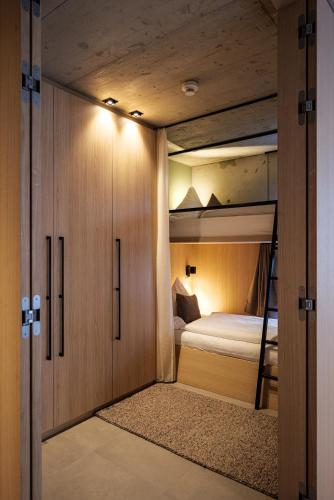 a bedroom with a bunk bed with a ladder in it at Lebe`oetz - Das Ferienapartmenthaus im Zentrum von Oetz in Oetz