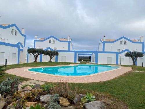 a large building with a swimming pool in a yard at CASA NA COLINA - MORADIA com PISCINA in Tavira