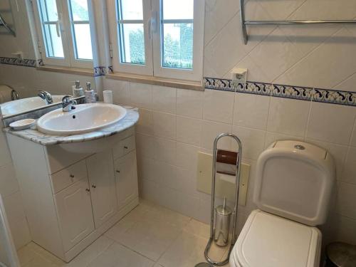 a bathroom with a sink and a toilet at CASA NA COLINA - MORADIA com PISCINA in Tavira