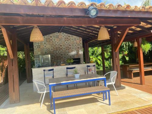 a patio with a table and chairs on a deck at Costa do Sauipe Casa dentro do complexo hoteleiro in Costa do Sauipe