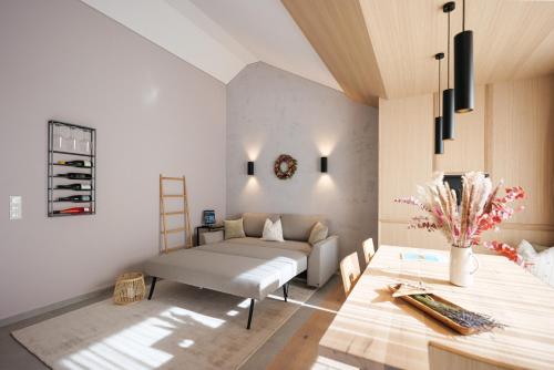 a living room with a couch and a table at Lebe`oetz - Das Ferienapartmenthaus im Zentrum von Oetz in Oetz