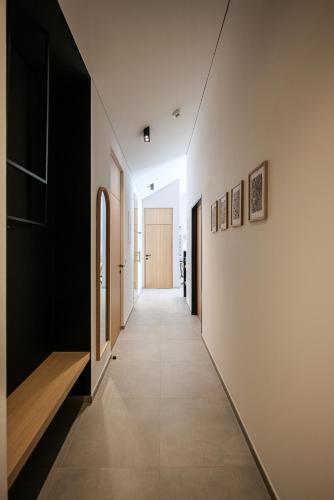 a hallway of a house with white walls and a long hallway at Lebe`oetz - Das Ferienapartmenthaus im Zentrum von Oetz in Oetz