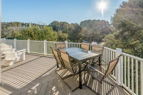 a wooden deck with a table and chairs on it at Sounds Great! in Duck