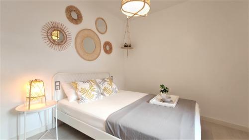 sypialnia z łóżkiem, stołem i lustrami w obiekcie Apartamento San Nicolás - tranquilidad y comodidad en el centro de Murcia w Murcji