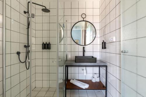 a bathroom with a sink and a mirror at Selina Neve Tzedek Tel Aviv in Tel Aviv
