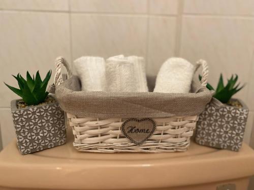 a basket of towels sitting on top of a toilet at Diamond Apartment with stunning sea view in Paphos