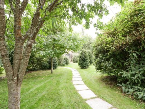 a path in a garden with trees and grass at The Barn at Frog Pond Farm in Salisbury